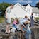 A family uses scoop nets to fish at a small pond outside Vagsberget Museum